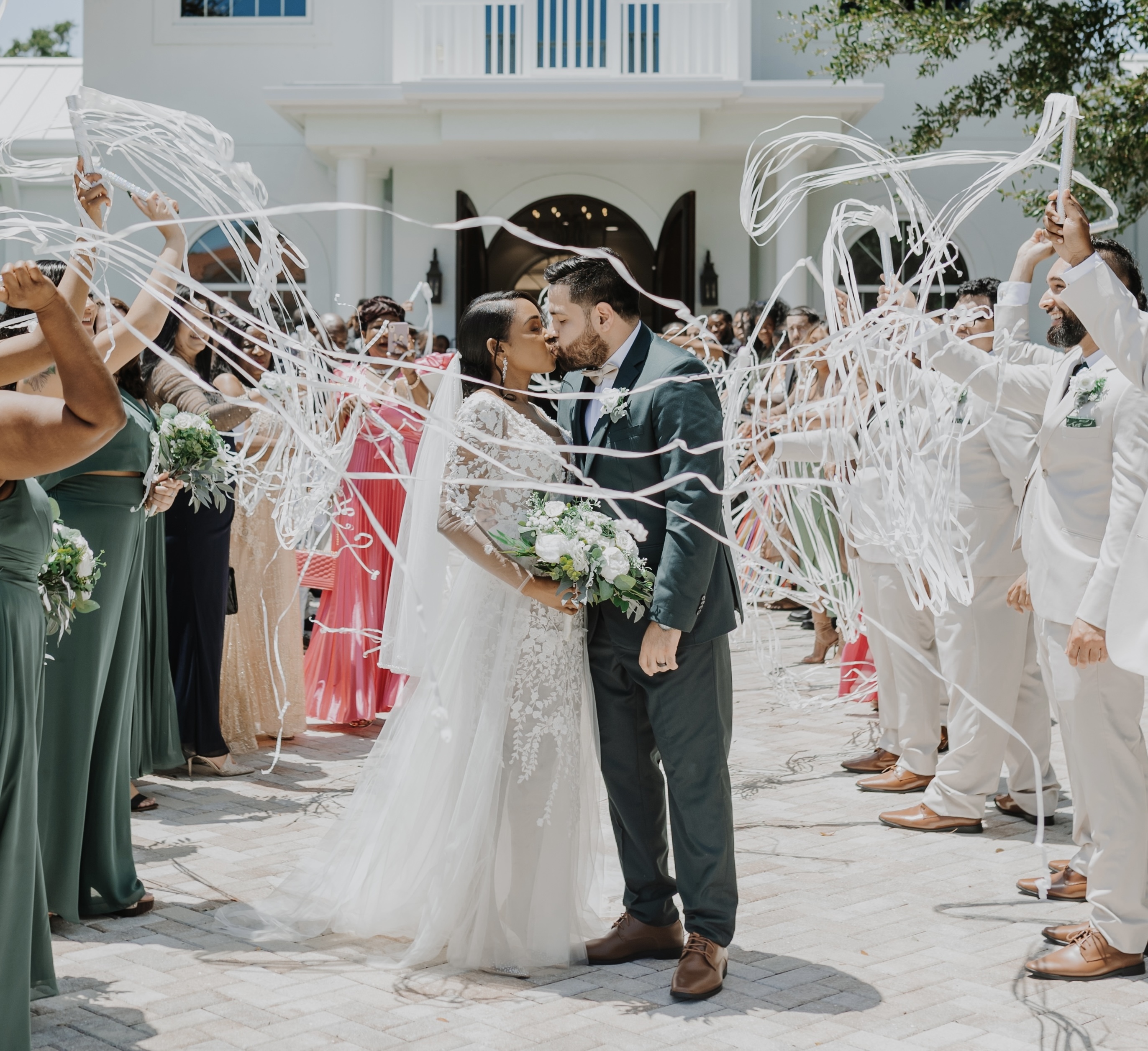 Guests launch Flutter FETTI® Finger Slingers during a wedding celebration, filling the air with shimmering flameproof metallic streamers—no cleanup required.